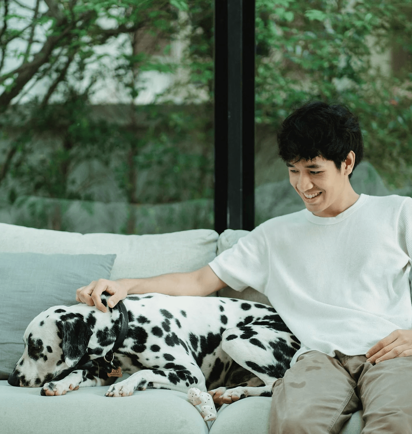 A Man with his dalmation on a couch